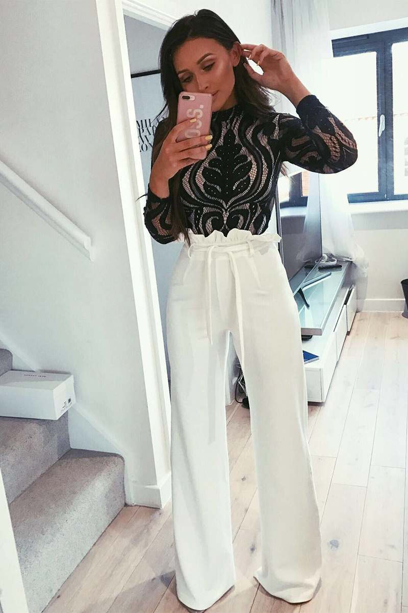 tall white flared high waisted paperbag trousers